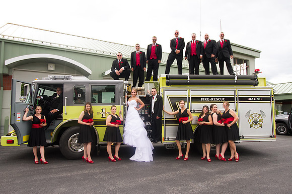 The wedding party posed on a firetruck.